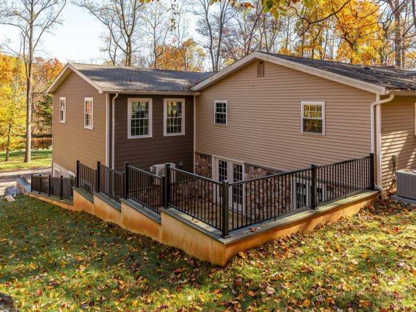 fenced in steps heading to custom home and garage