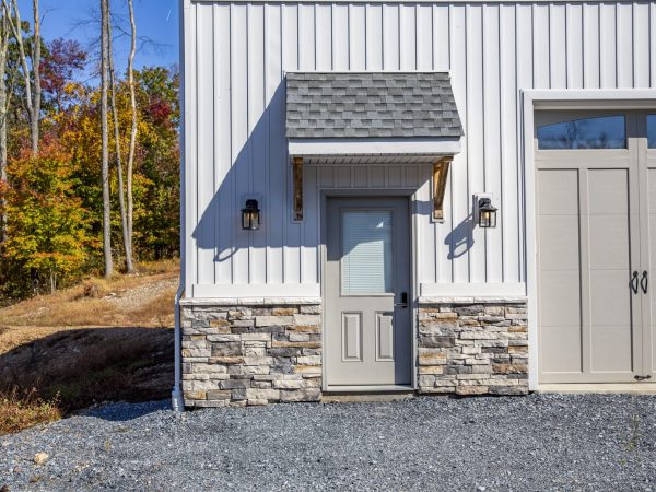 door with overhang attached to metal garage addition