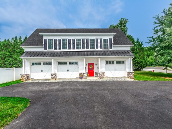 white three car garage with red door