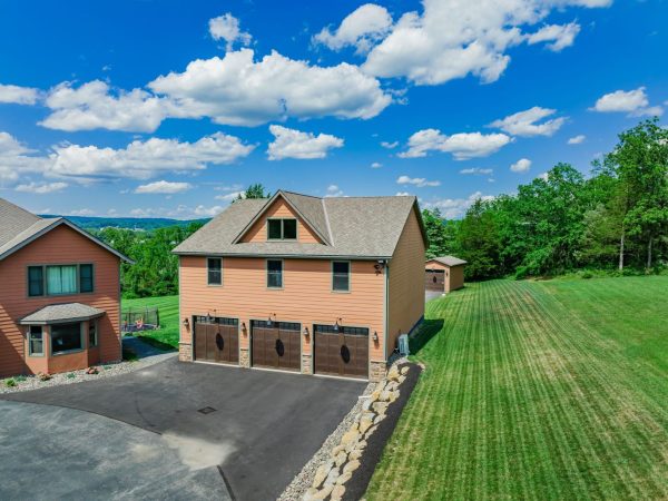 full three car garage view with house