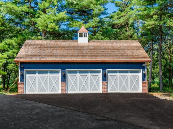 front of blue metal three car garage