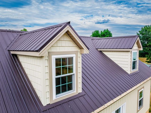 Close-up of a brown metal roof with dormer windows on a detached garage.