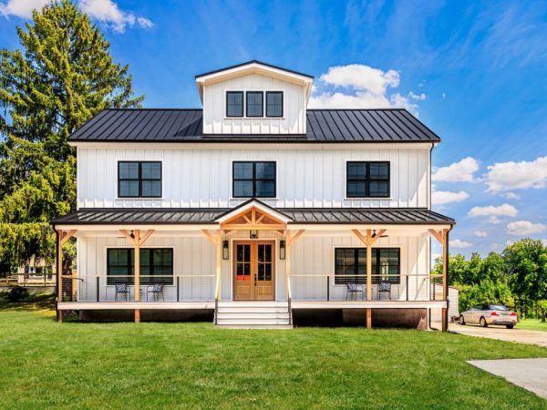 Centered front view of a modern farmhouse with symmetrical porch design.
