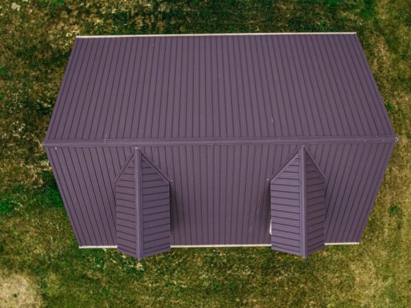 Overhead view of a brown metal roof with two dormers on a detached garage.