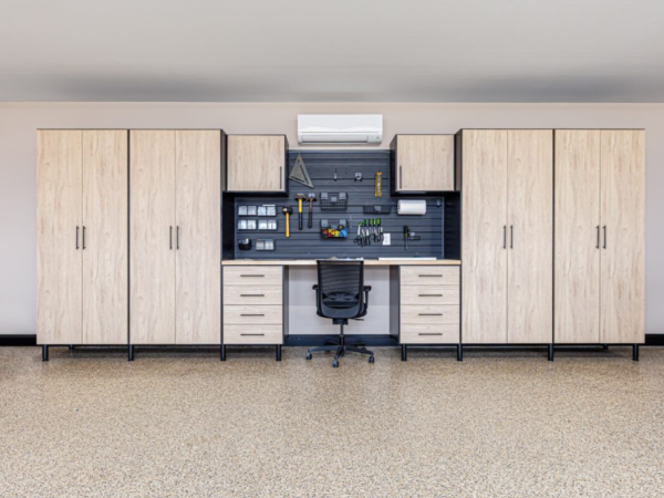 close up of modern workbench and cabinetry setup with pegboard and overhead mini split